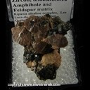 Minerals Specimen: Zircon with undetermined Amphibole and Feldspar from Kipawa alkaline complex, Temiscamingue RCM, Abitibi-Temiscamingue, Quebec, Canada Minerals Specimen: Zircon with undetermined Amphibole and Feldspar from Kipawa alkaline complex, Temiscamingue RCM, Abitibi-Temiscamingue, Quebec, Canada