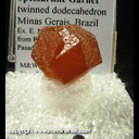 Mineral Specimen: Spessartine Garnet twinned dodecahedron from Minas Gerais, Brazil, Ex. E. Morales, from Roberts Minerals, Tucson show, 1983 Mineral Specimen: Spessartine Garnet twinned dodecahedron from Minas Gerais, Brazil, Ex. E. Morales, from Roberts Minerals, Tucson show, 1983