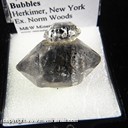 Mineral Specimen: Quartz, variety Herkimer Diamond with included Hydrocarbons and Gas Bubbles from Herkimer, New York, Ex. Norm Woods Mineral Specimen: Quartz, variety Herkimer Diamond with included Hydrocarbons and Gas Bubbles from Herkimer, New York, Ex. Norm Woods