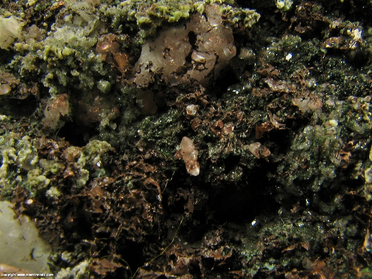 Mineral Specimen: Pumpellyite-Mg, Copper, Calcite with included Copper, Quartz and Microcline in Amygdule Basalt from Keweenaw Couny, Michigan, USA