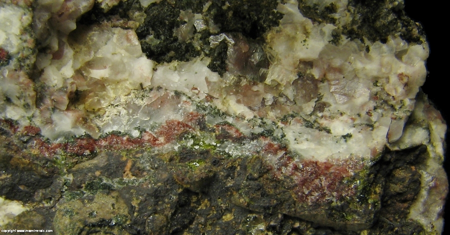 Mineral Specimen: Pumpellyite-Mg, Copper, Calcite with included Copper, Quartz and Microcline in Amygdule Basalt from Keweenaw Couny, Michigan, USA