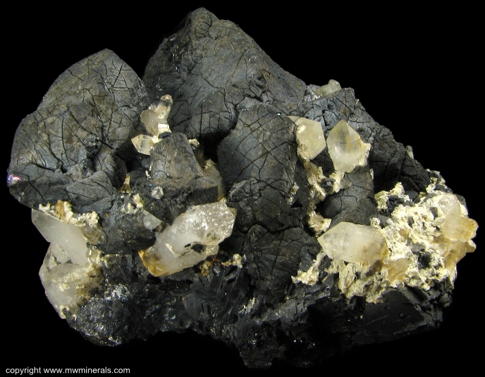 Mineral Specimen: Chalcopyrite and Quartz  on Hedenbergite from El Mochito Mine, El Mocho, Santa Barbara Department, Honduras