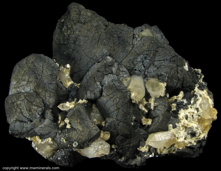 Mineral Specimen: Chalcopyrite and Quartz  on Hedenbergite from El Mochito Mine, El Mocho, Santa Barbara Department, Honduras