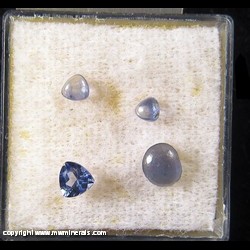 Mineral Specimen: Benitoite, 1 trillion cut and 3 cabochons from Gem Mine, San Benito Co., California Mineral Specimen: Benitoite, 1 trillion cut and 3 cabochons from Gem Mine, San Benito Co., California