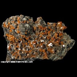 Mineral Specimen: Wulfenite, Calcite, Manganese Oxides from Jianshan Mine, Ruoqiang Co., Bayin'gholin Auton. Pref., Xinjiang Auton. Region, China